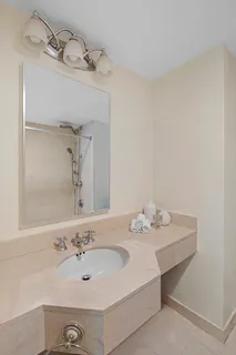 a bathroom with a sink vanity and a mirror
