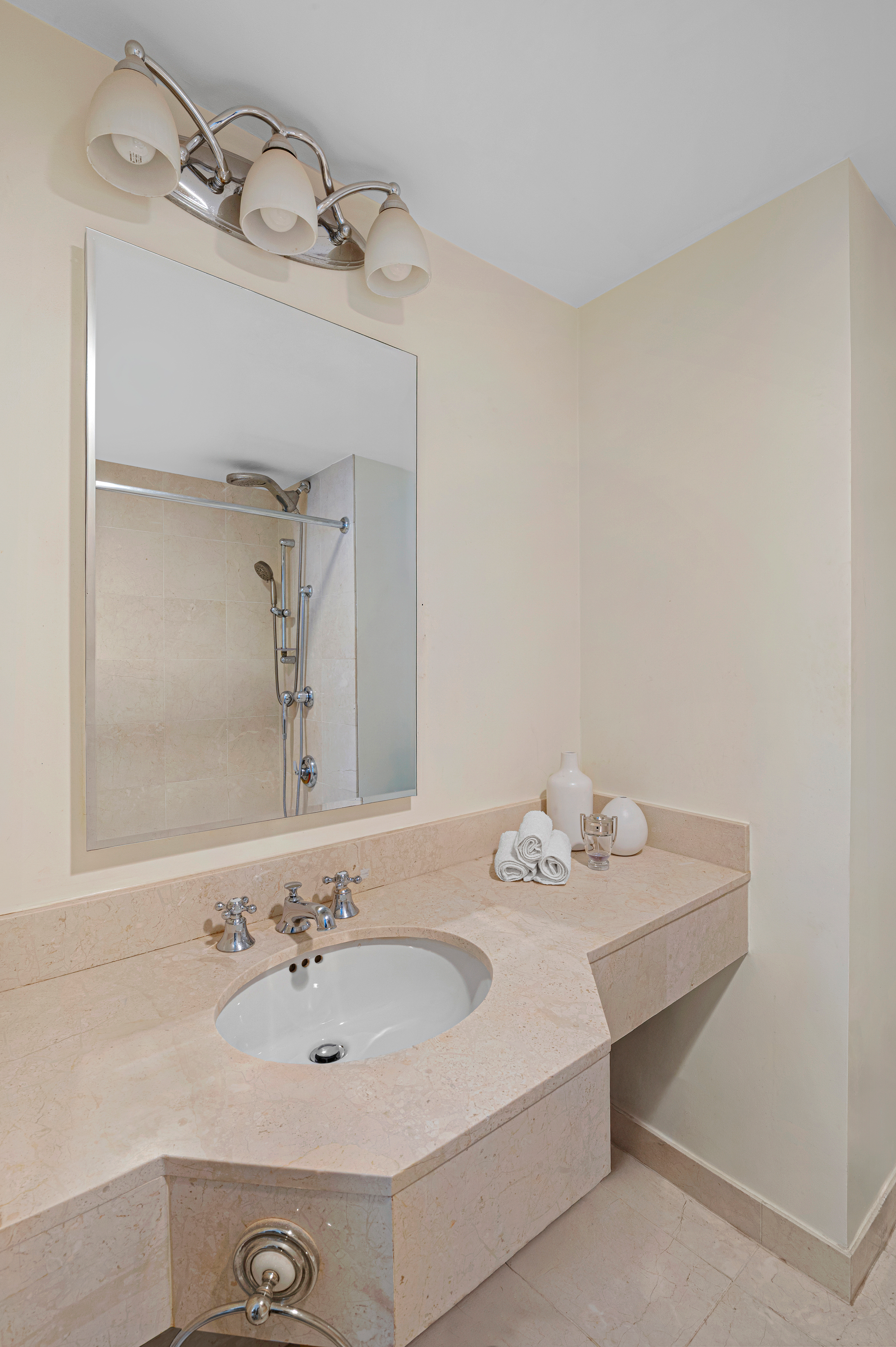 160 Central Park South, Unit 2307 Manhattan, NY 10019 - Photo 7 of 15 a bathroom with a sink vanity and a mirror