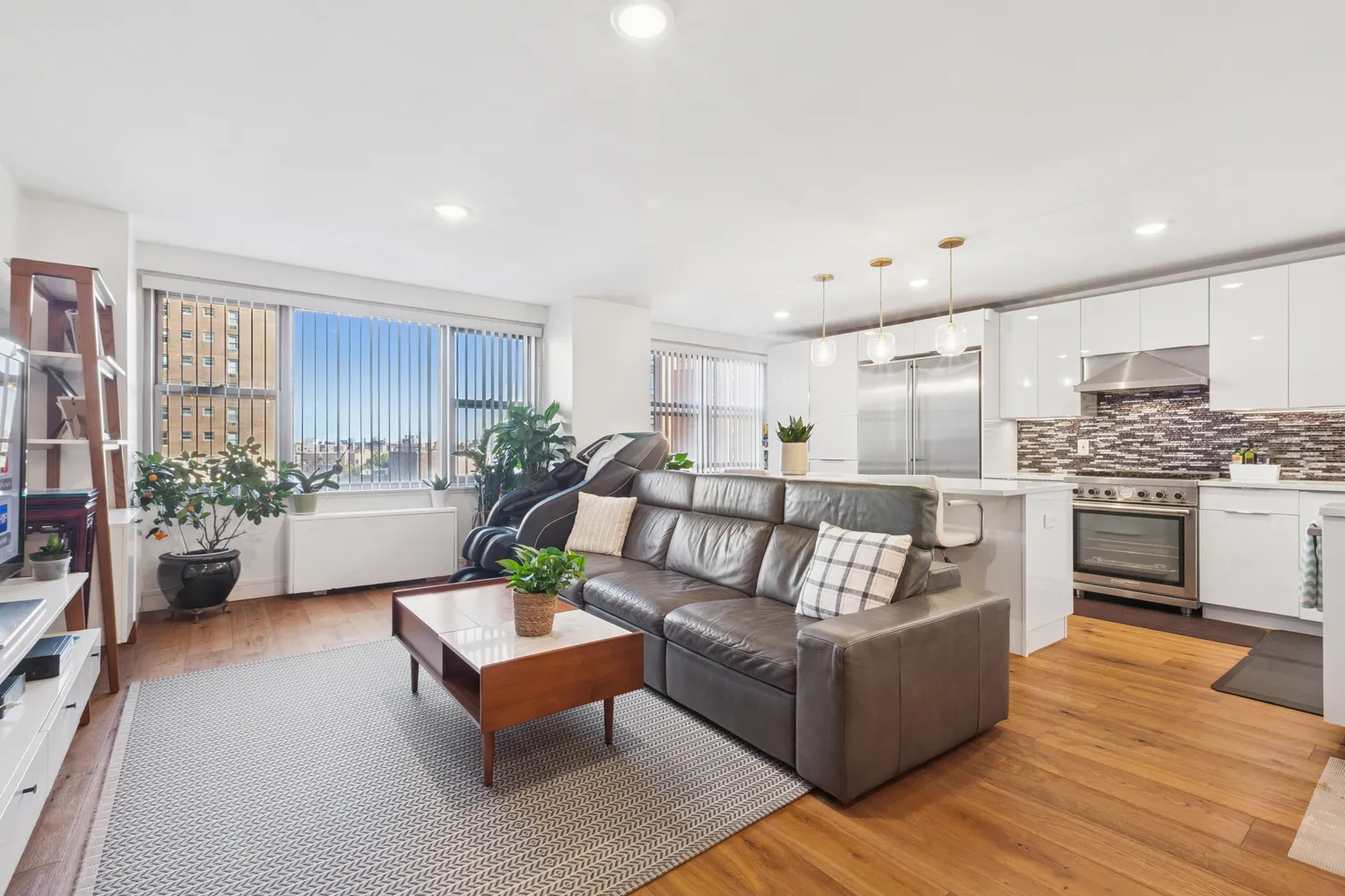 a living room with furniture and a kitchen