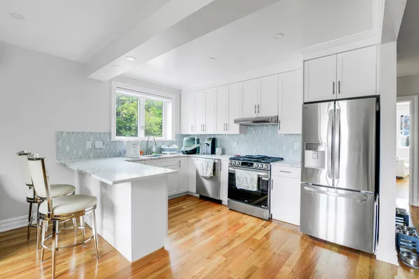 a kitchen with a refrigerator a stove a sink dishwasher and a refrigerator