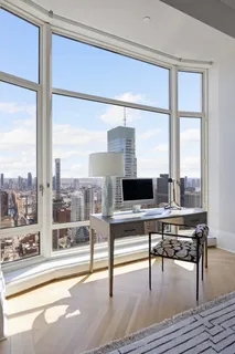 a living room with a table and a large window