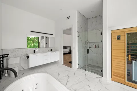 a bathroom with a bathtub sink and mirror