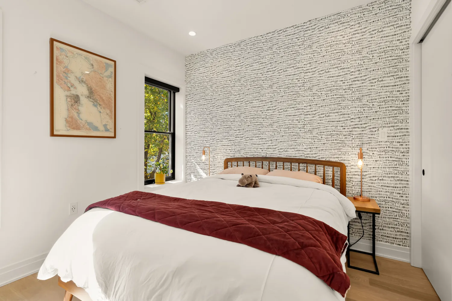 a bedroom with a bed and a painting on the wall