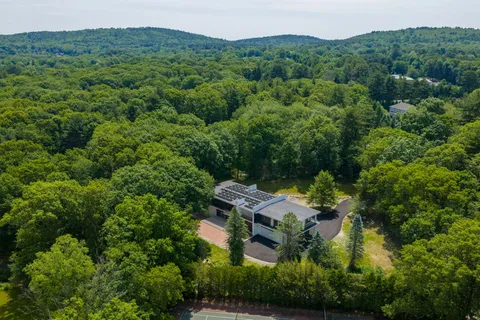 an aerial view of a house with yard