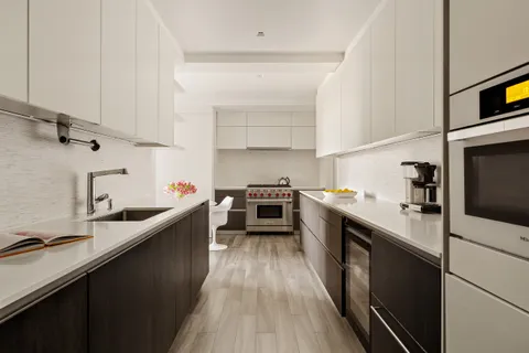 a kitchen with stainless steel appliances a sink stove and cabinets
