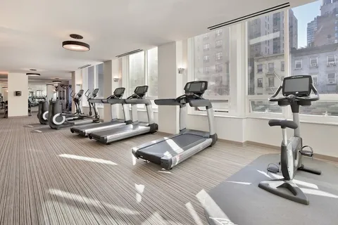 a room with gym equipment and a large window