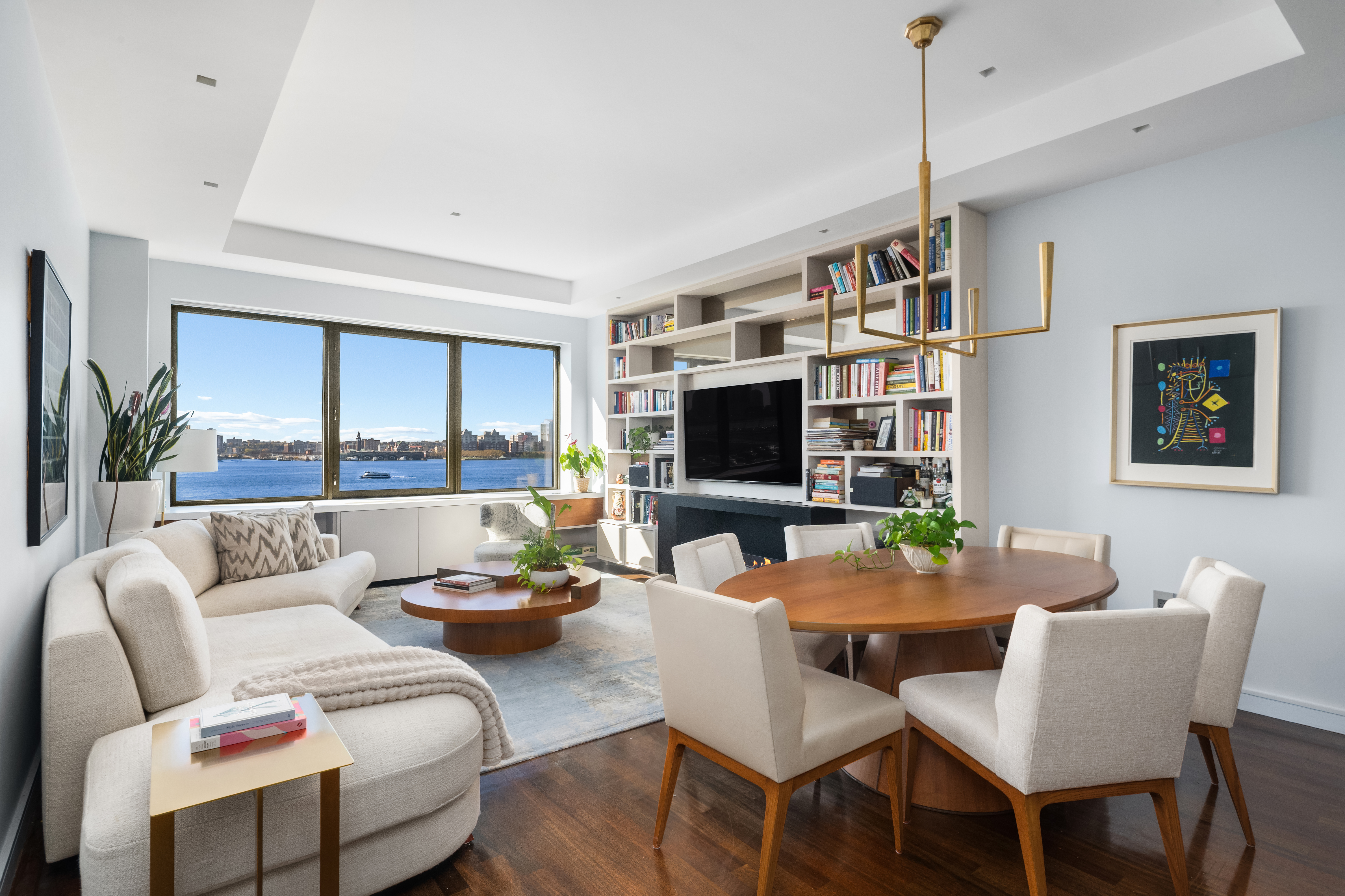 100 Morton Street, Unit 7EW Manhattan, NY 10014 - Photo 3 of 21 a living room with furniture a flat screen tv and a large window
