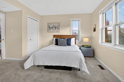 a bedroom with a bed and window