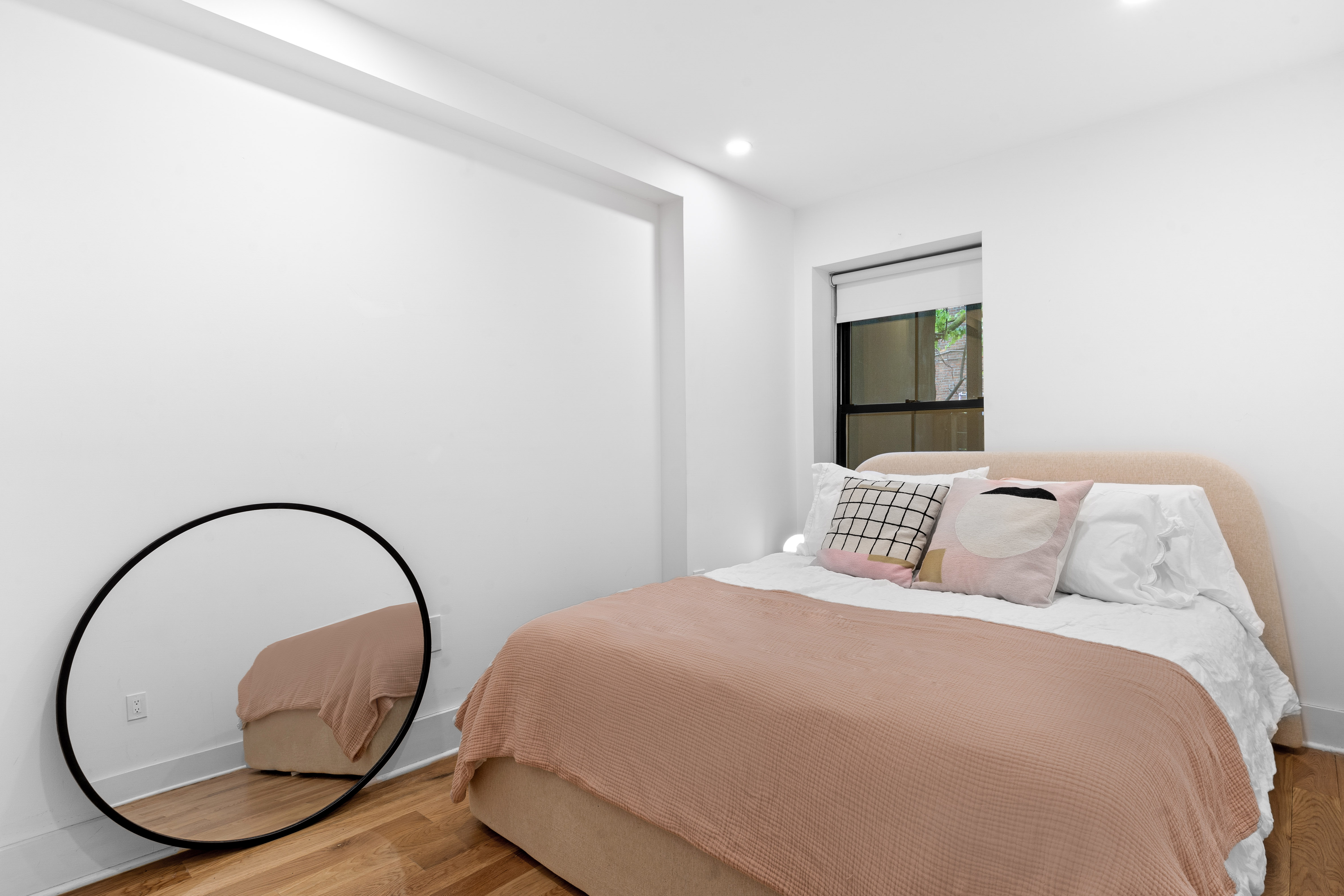 1591 Pacific Street Brooklyn, NY 11213 - Photo 13 of 16 a bedroom with a bed and a a mirror