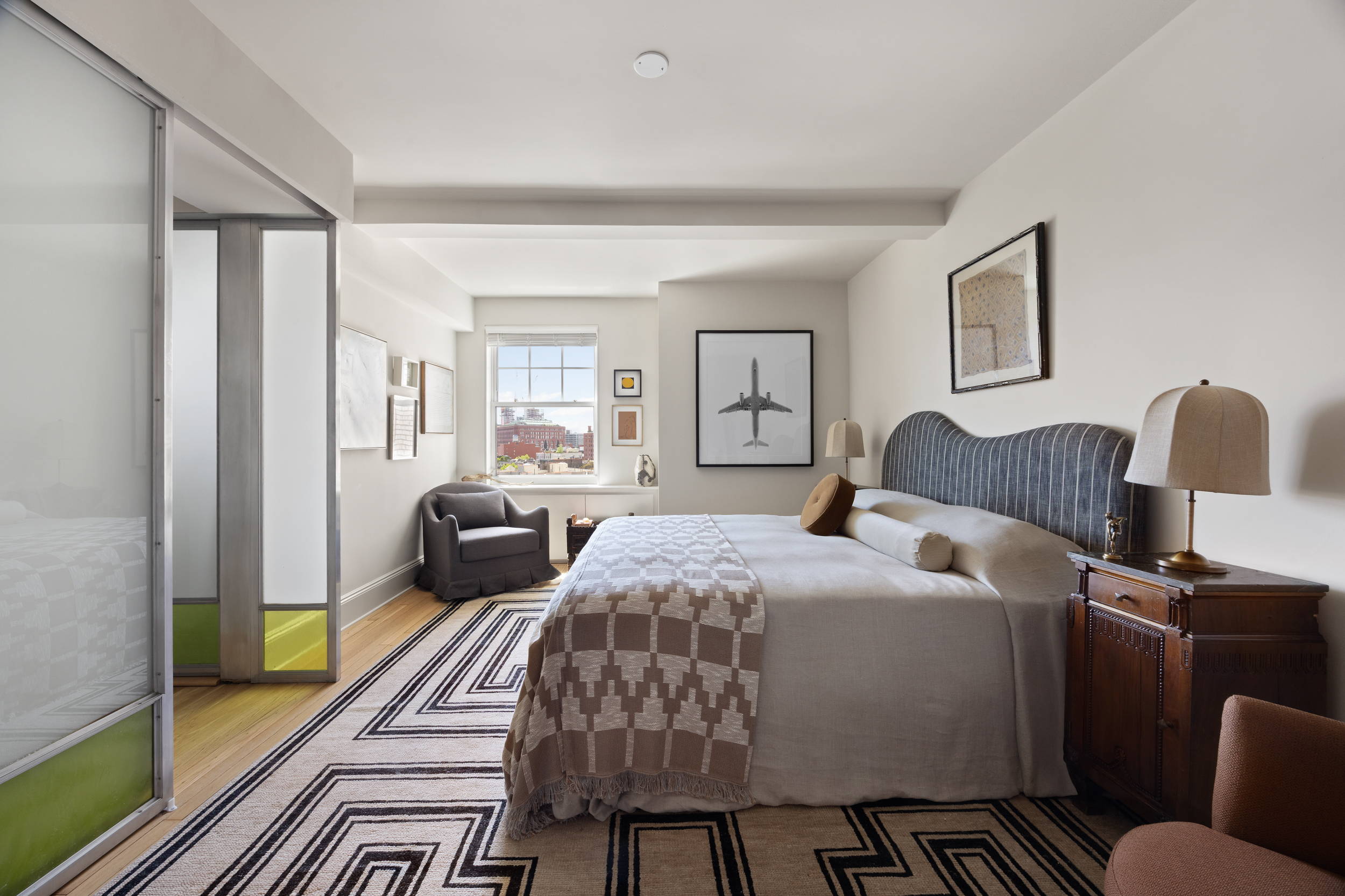 302 West 12th Street, Unit 11F Manhattan, NY 10014 - Photo 10 of 17 a bedroom with a bed and wooden floor