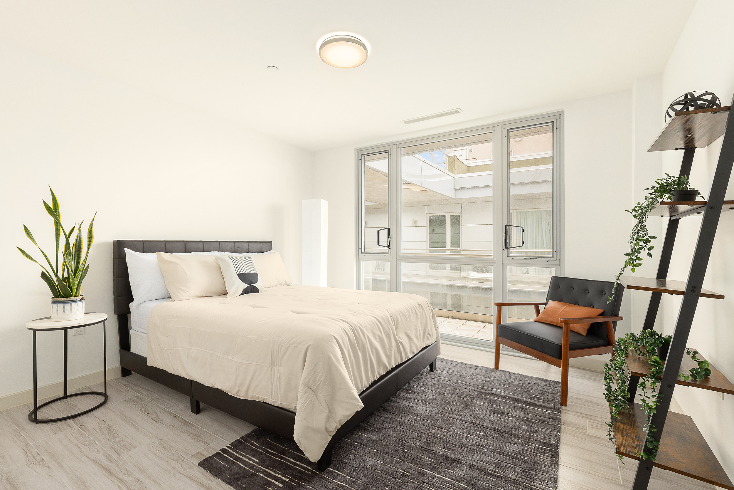 109-09 15th Avenue, Unit PHS611 Queens, NY 11356 - Photo 6 of 11 a bedroom with a bed and a large window