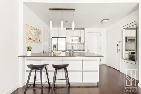 a kitchen with stainless steel appliances granite countertop a sink and a refrigerator