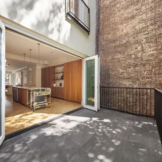 a view of a porch with a table and chairs