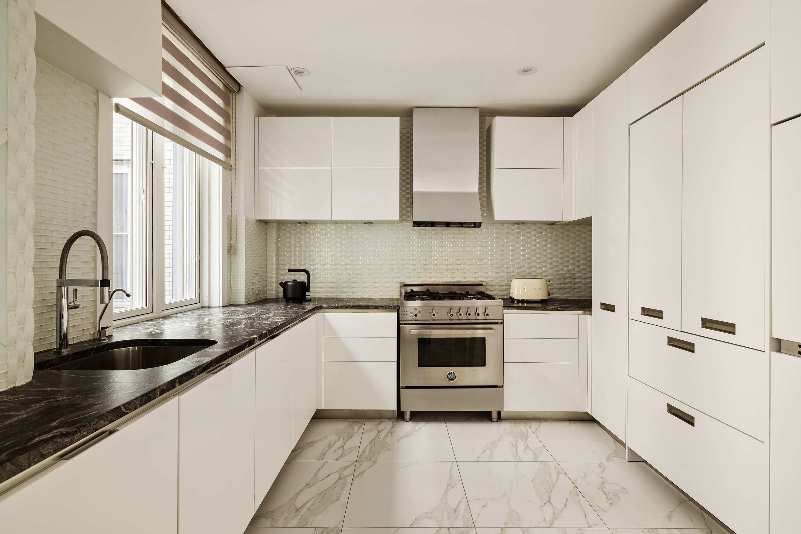 251 West 98th Street, Unit 7B Manhattan, NY 10025 - Photo 2 of 14 a kitchen with stainless steel appliances a sink a stove and white cabinets