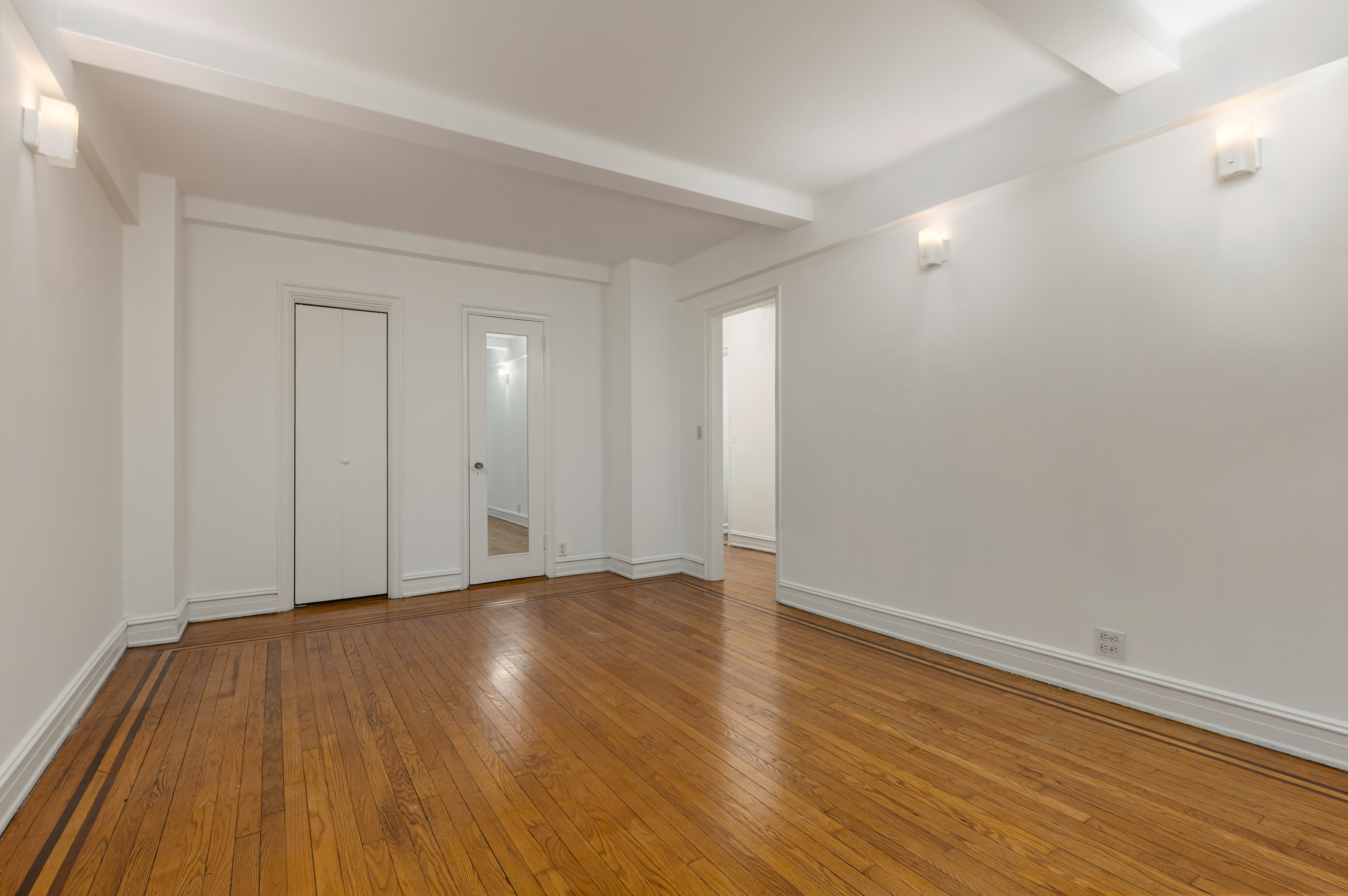 235 West 102nd Street, Unit 4E Manhattan, NY 10025 - Photo 7 of 19 a view of an empty room with wooden floor