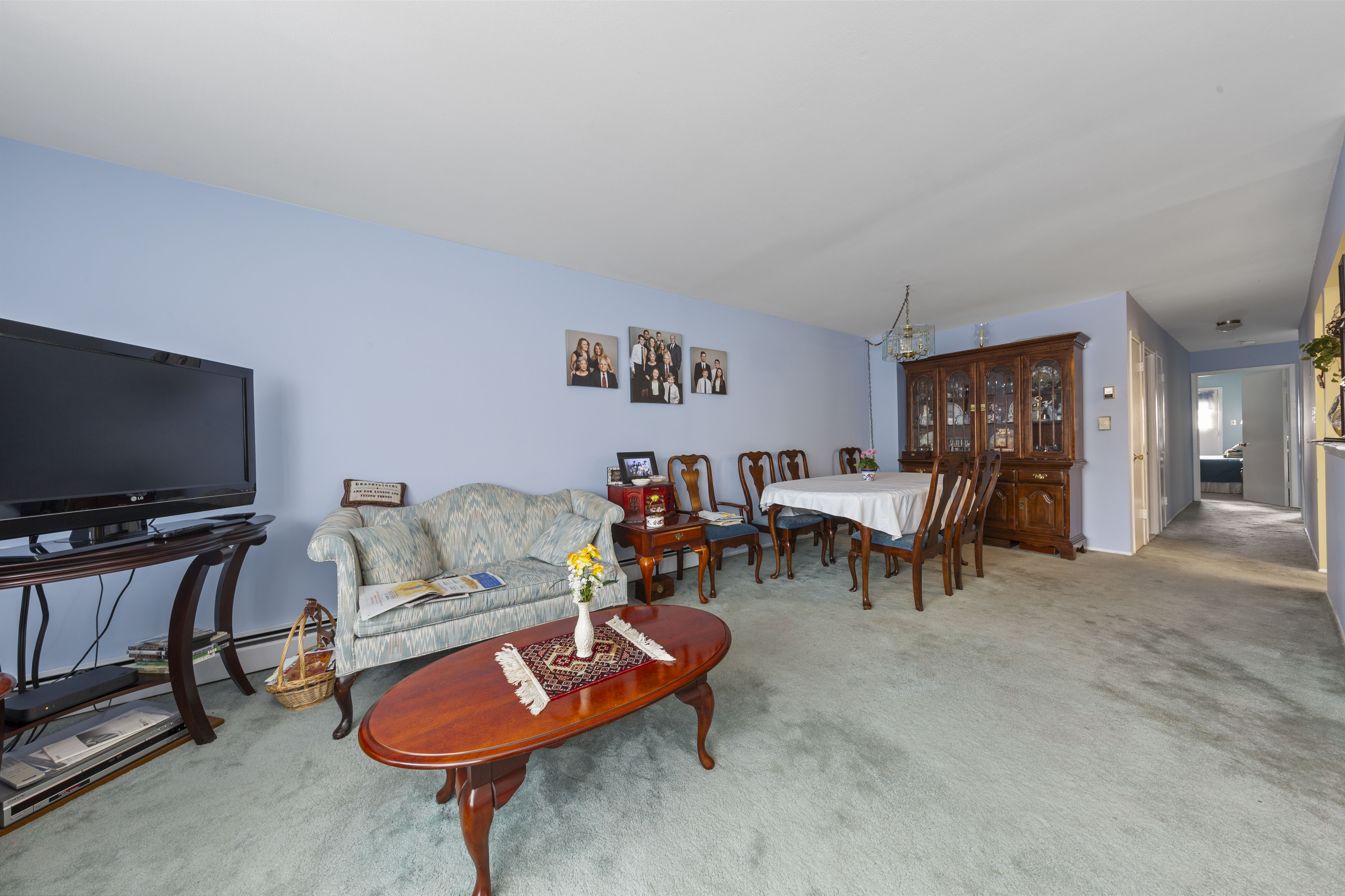 240-47 68th Avenue Queens, NY 11362 - Photo 6 of 39 a living room with furniture and a flat screen tv