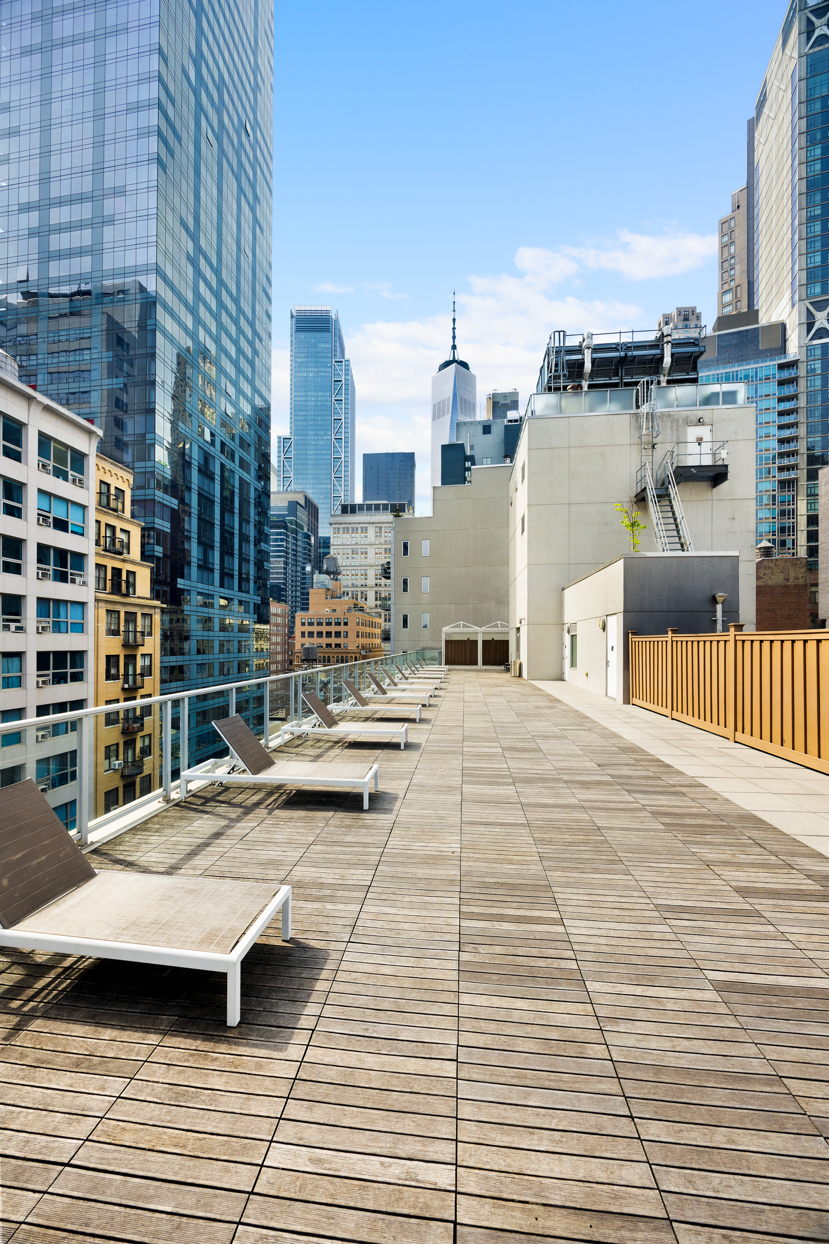 111 Fulton Street, Unit 824 Manhattan, NY 10038 - Photo 34 of 35 a roof deck with glass top table and chairs