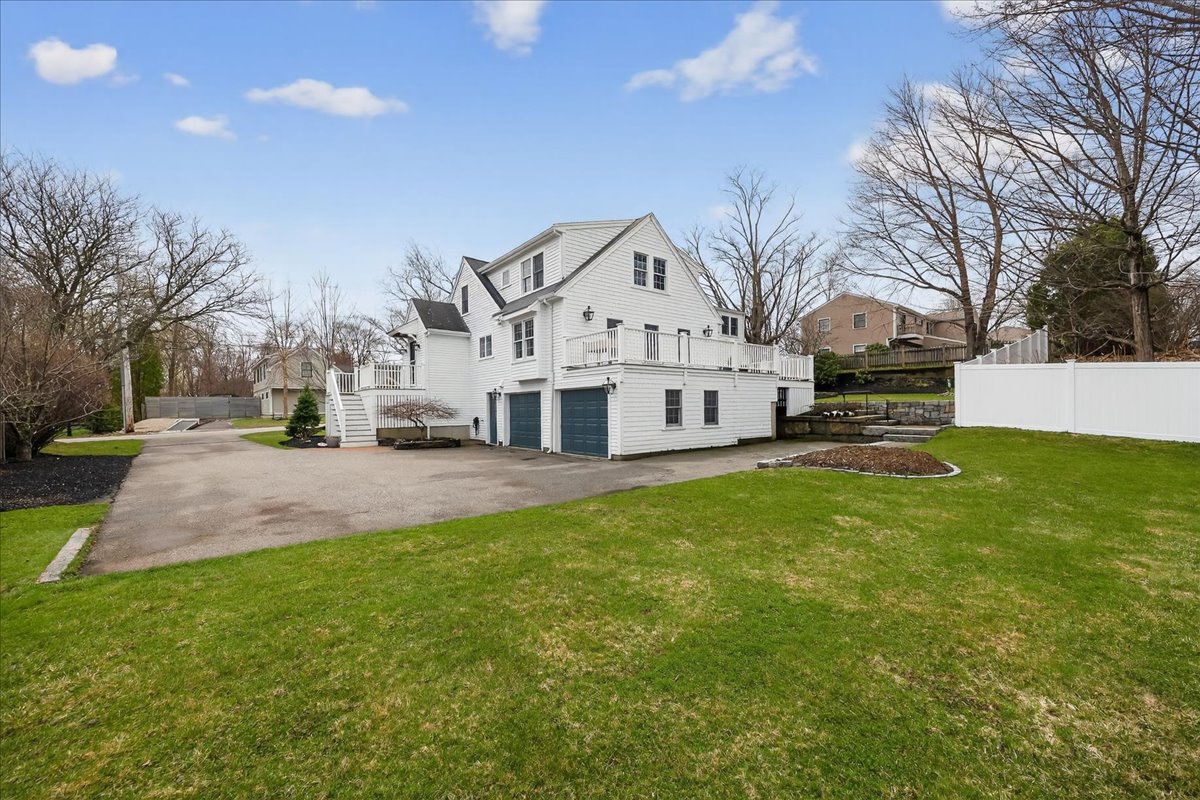 6 Studley Road Hingham, MA 02043 - Photo 23 of 27 a view of a white house next to a yard with big trees