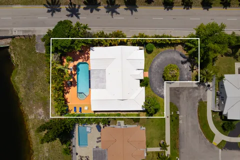 an aerial view of a house with a garden and swimming pool