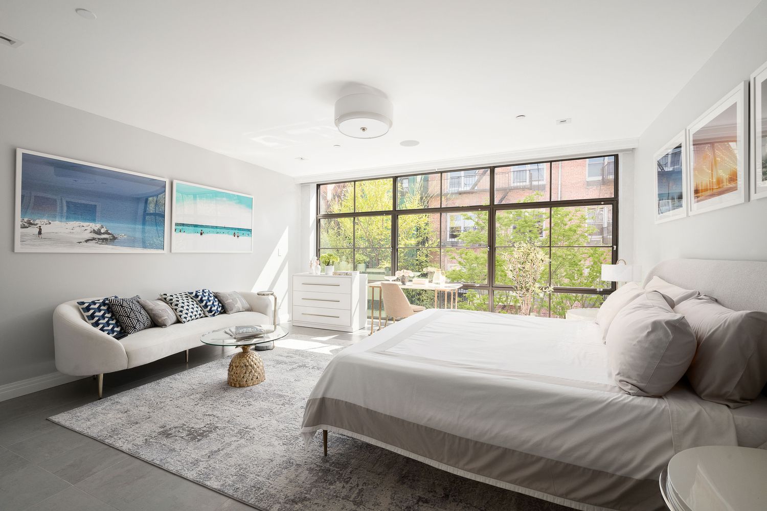 520 East 89th Street Manhattan, NY 10128 - Photo 25 of 40 a spacious bedroom with a bed and glass window