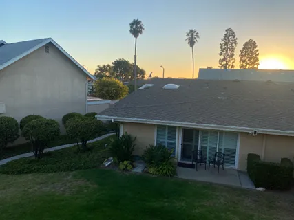 a view of a house with a yard and a garden