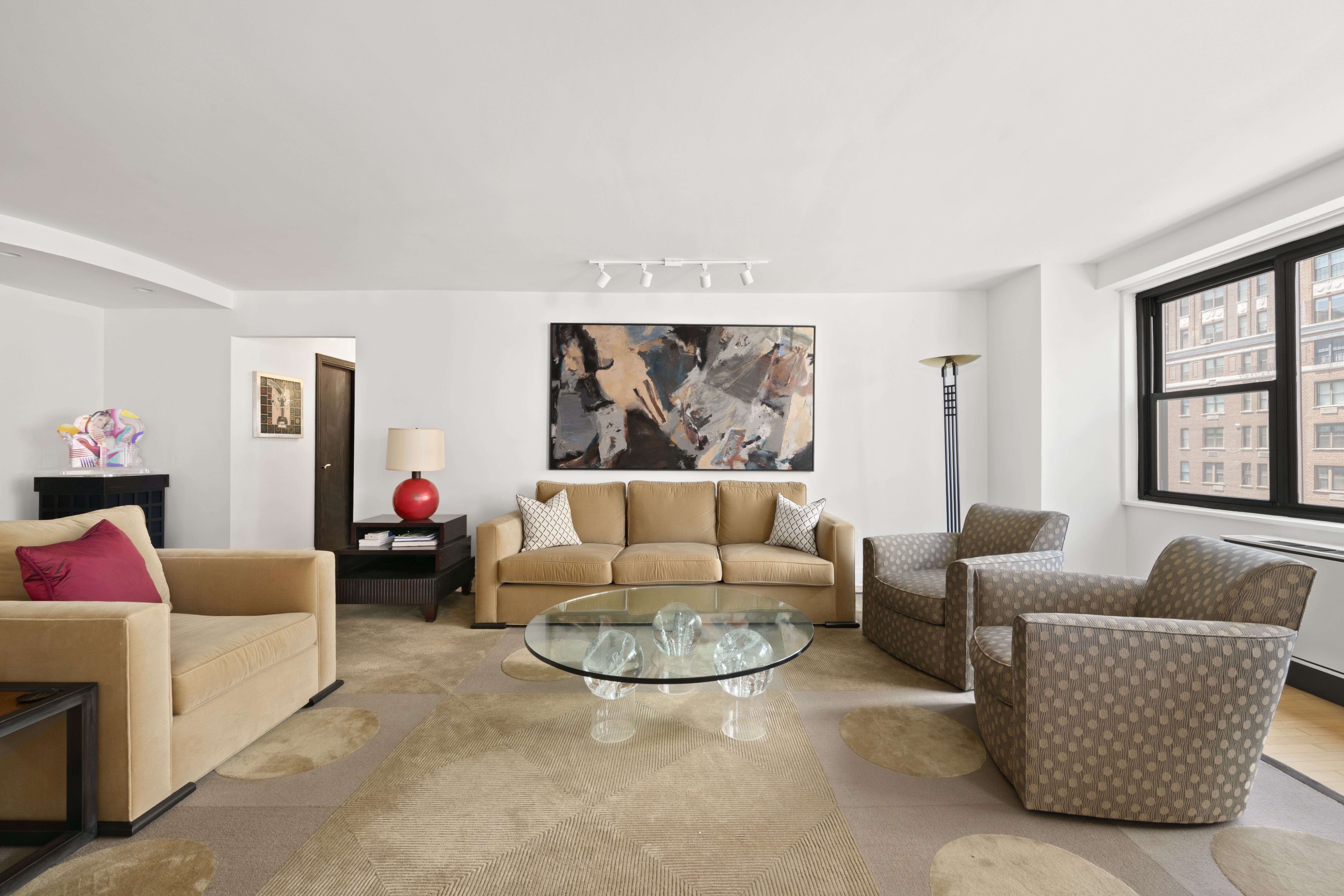 1065 Park Avenue, Unit 11A Manhattan, NY 10128 - Photo 2 of 14 a living room with furniture and a large window