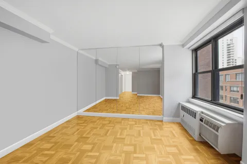 a bedroom with a bed and a large window