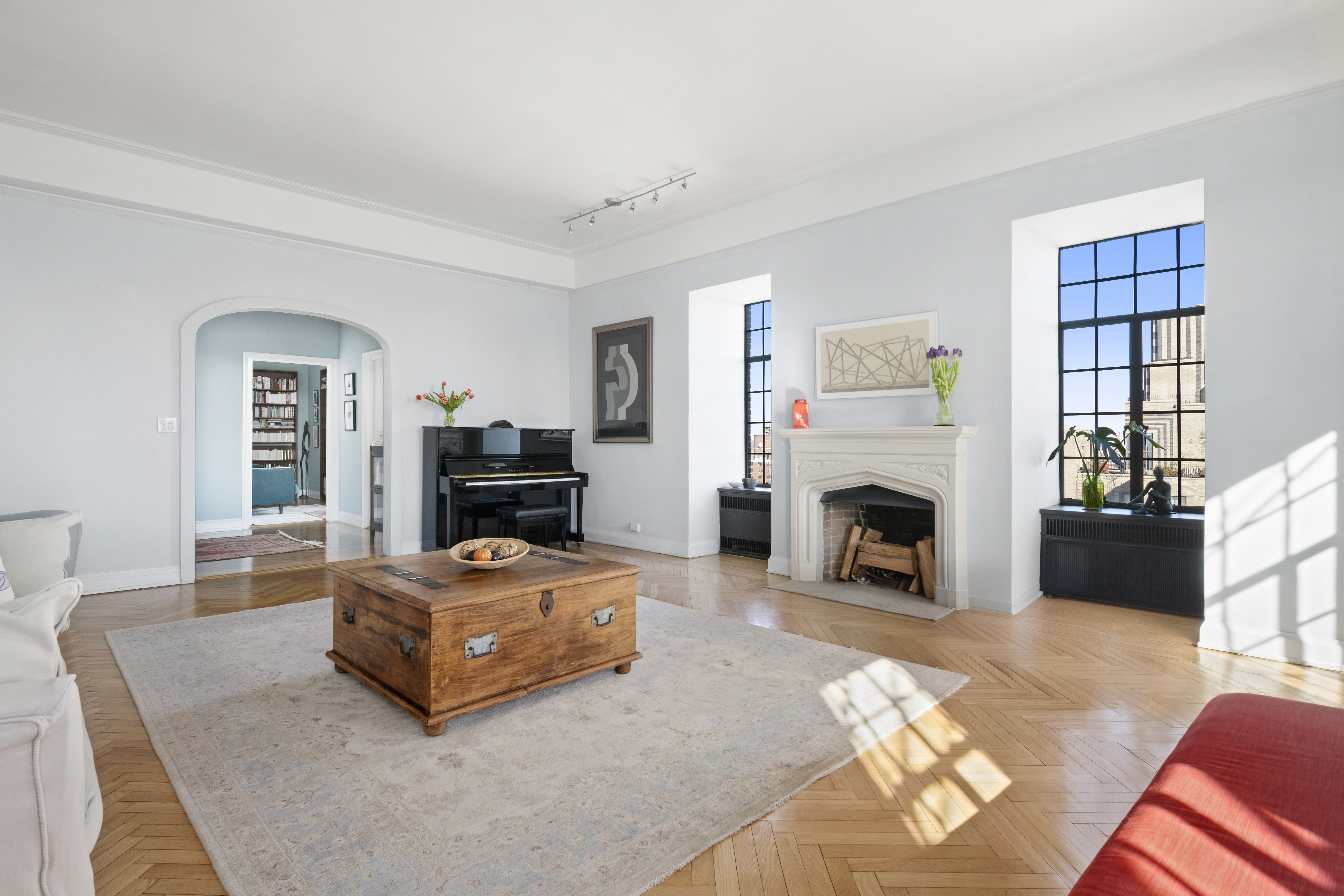 300 Central Park West, Unit 21G Manhattan, NY 10024 - Photo 2 of 21 a living room with furniture a fireplace and a flat screen tv