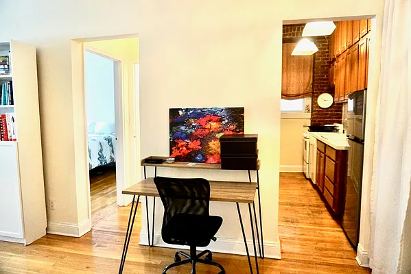 30 East 95th Street, Unit 2E Manhattan, NY 10128 - Photo 4 of 6 a view of a hallway with wooden floor and furniture