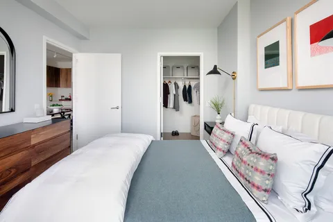 a bedroom with a bed and a couch