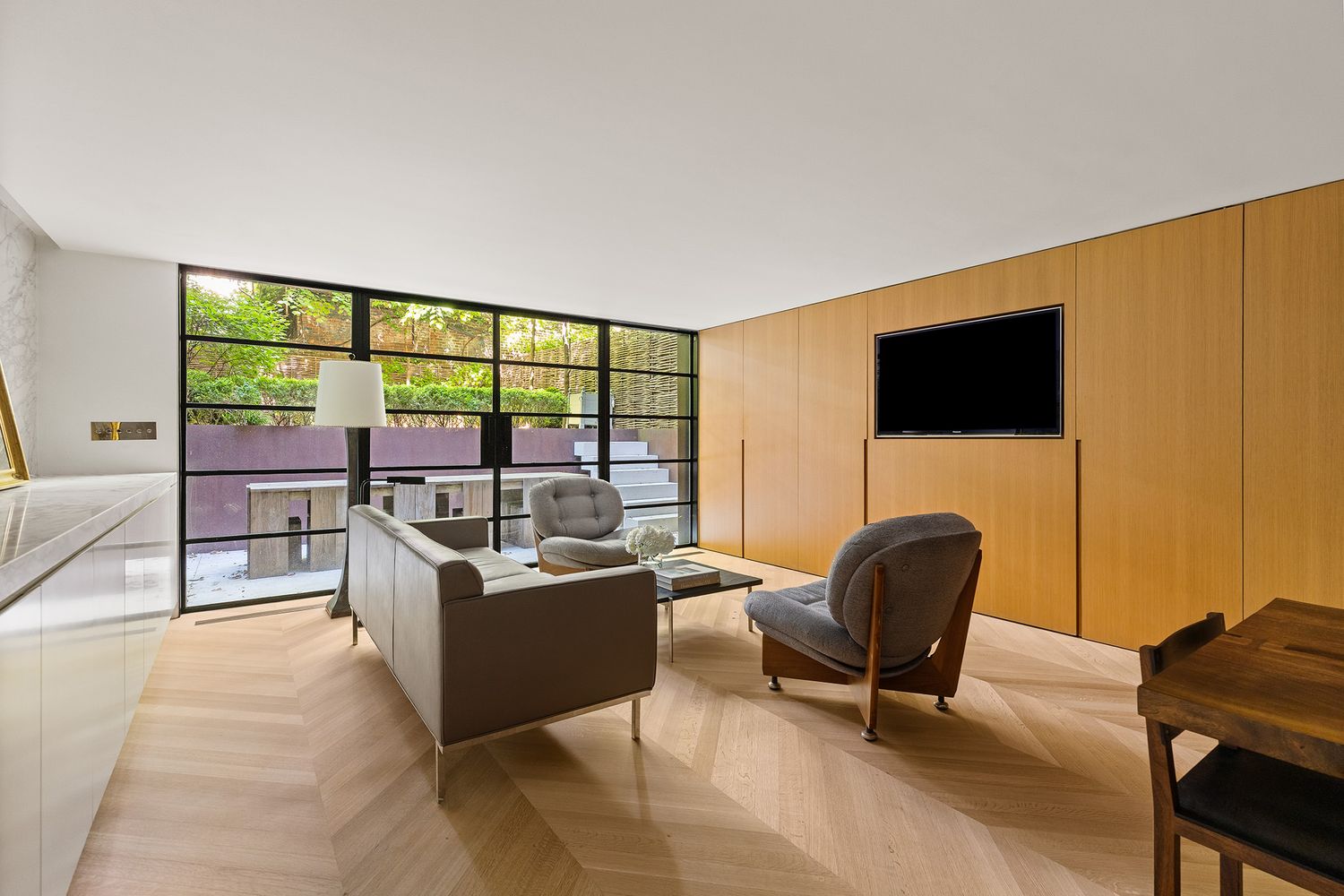 a living room with furniture and a flat screen tv