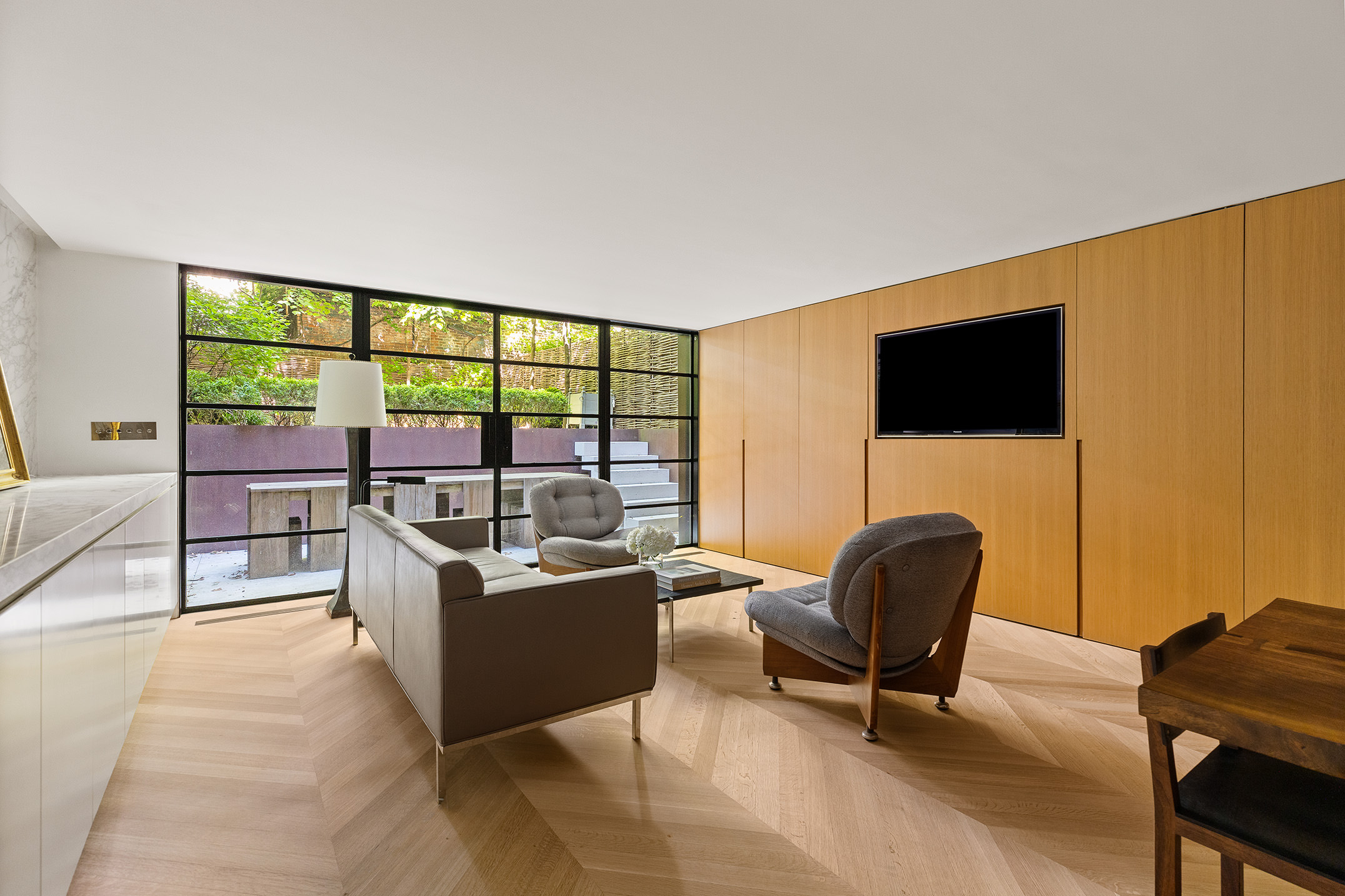 55 West 9th Street Manhattan, NY 10011 - Photo 13 of 20 a living room with furniture and a flat screen tv