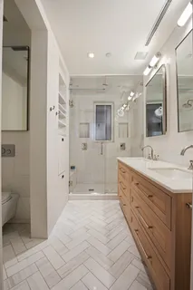 a spacious bathroom with a granite countertop sink mirror and toilet