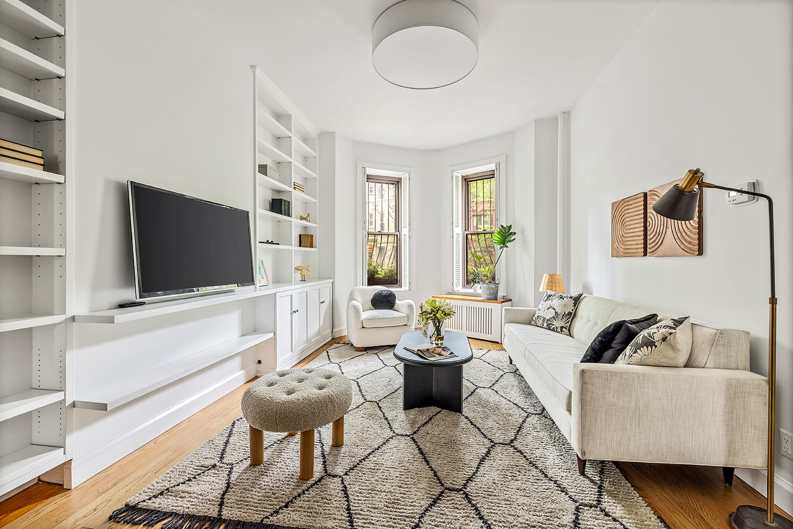 a living room with furniture and a flat screen tv