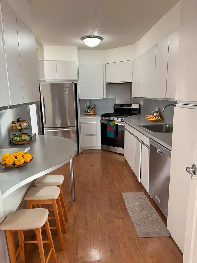a kitchen with stainless steel appliances and wooden cabinets