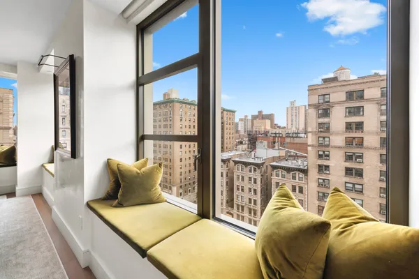 a bedroom with furniture and a large window