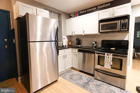 a kitchen with a refrigerator stove and microwave
