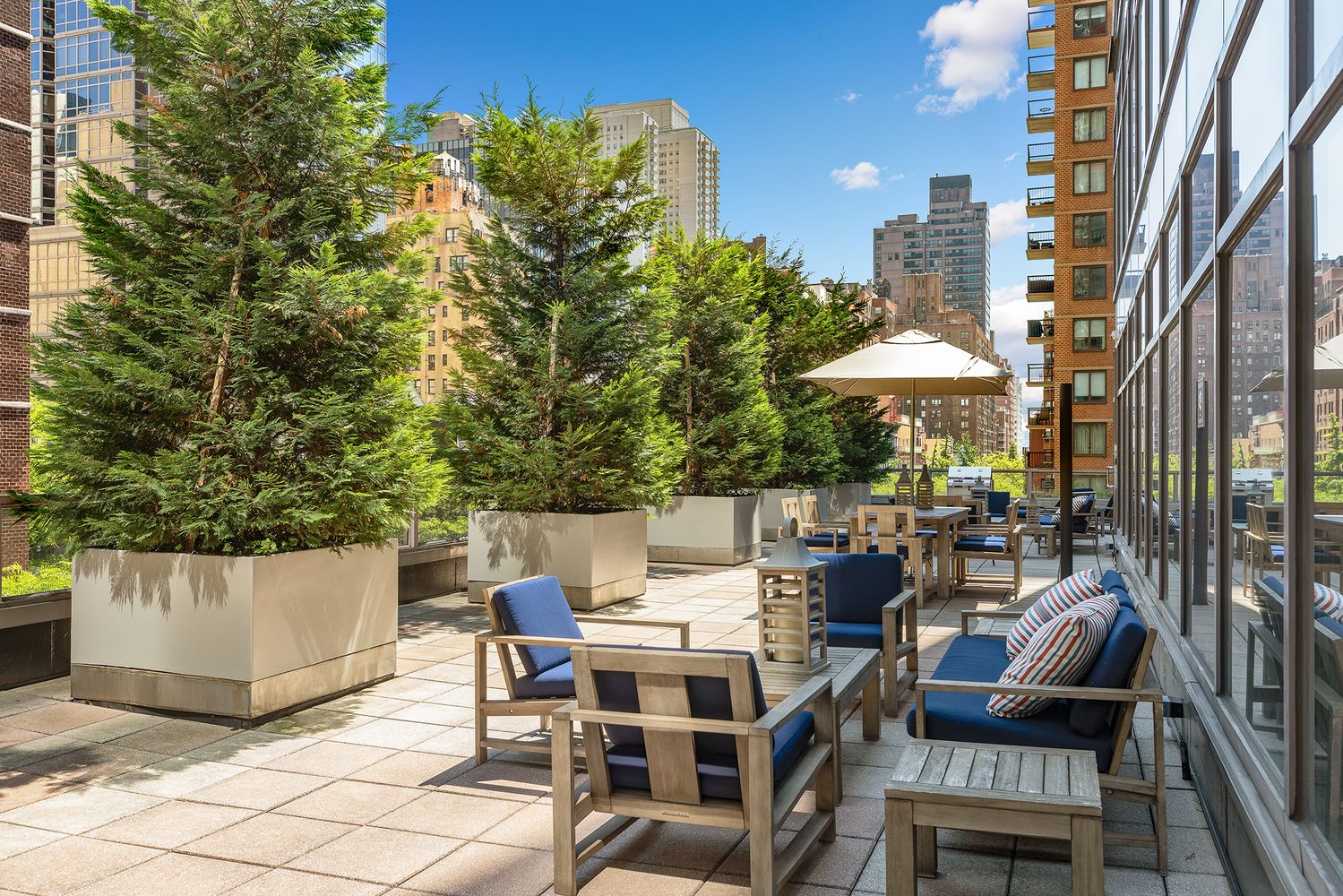 250 East 54th Street, Unit 6A Manhattan, NY 10022 - Photo 9 of 13 a view of a patio with table and chairs and potted plants