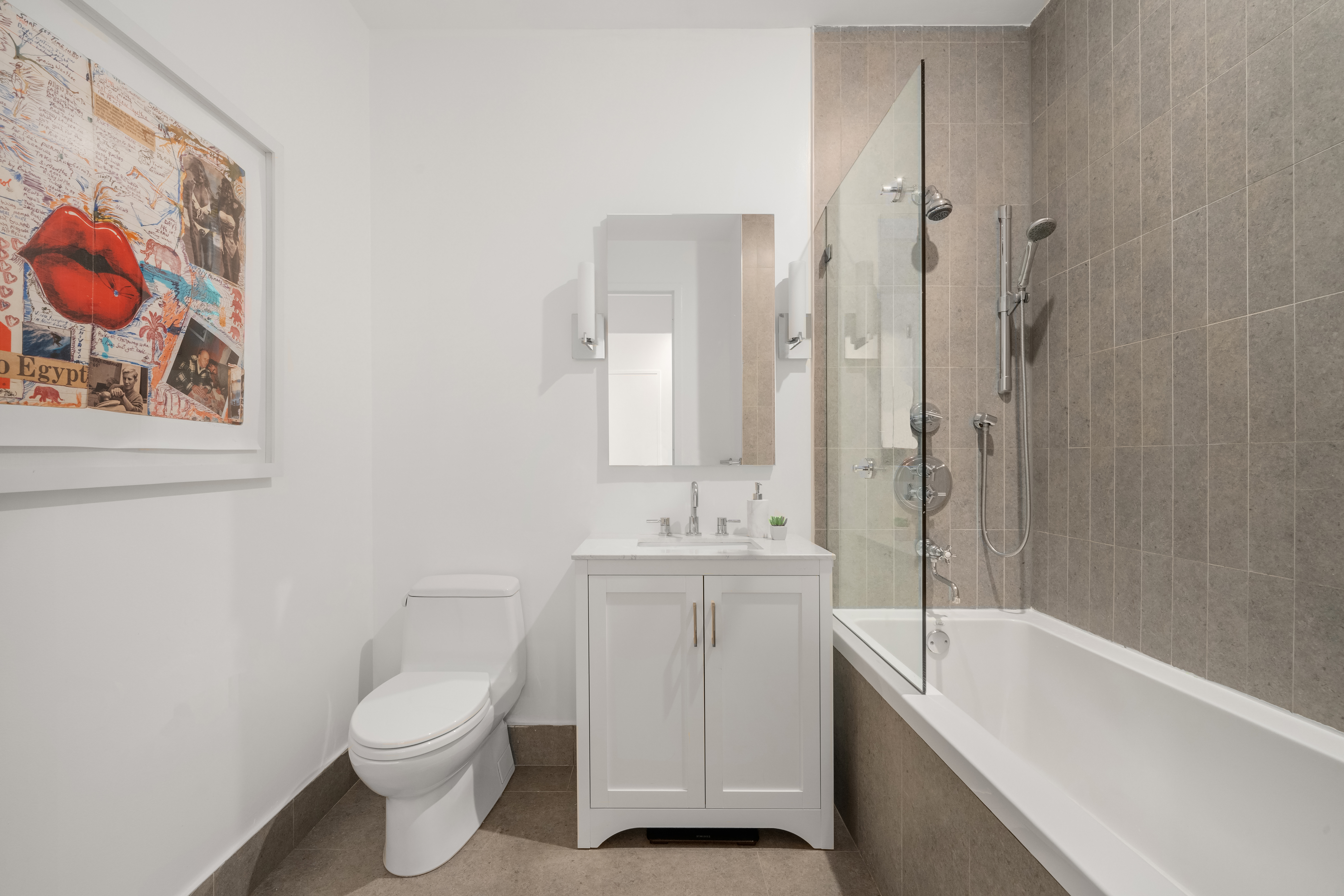 59 John Street, Unit 7D Manhattan, NY 10038 - Photo 8 of 10 a bathroom with a toilet sink and mirror
