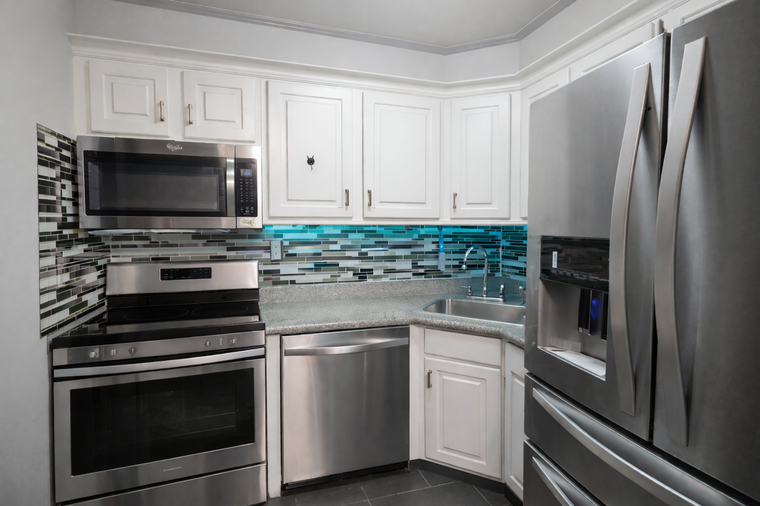 408 8th Avenue, Unit 5C Manhattan, NY 10001 - Photo 10 of 17 a kitchen with white cabinets and stainless steel appliances