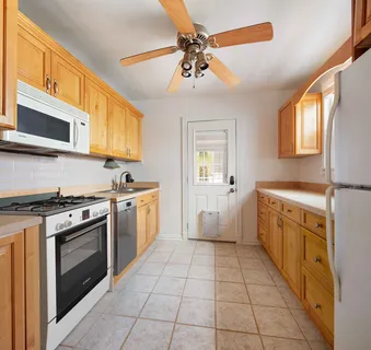 a kitchen with a stove top oven sink and cabinets