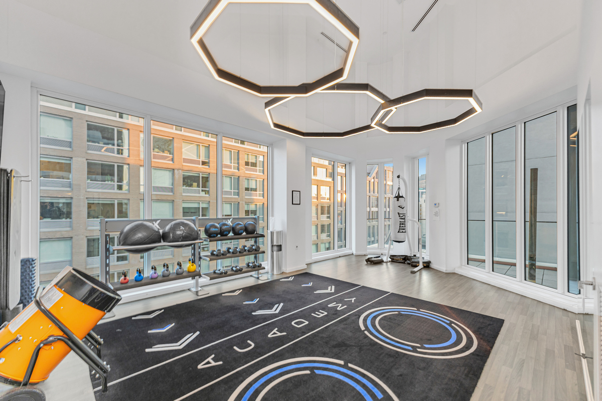 24-16 Queens Plaza South, Unit 4J Queens, NY 11101 - Photo 12 of 15 a view of swimming pool with furniture and floor to ceiling window