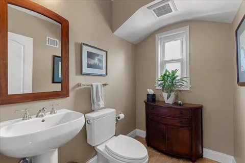 a room with a table chairs and ceiling fan