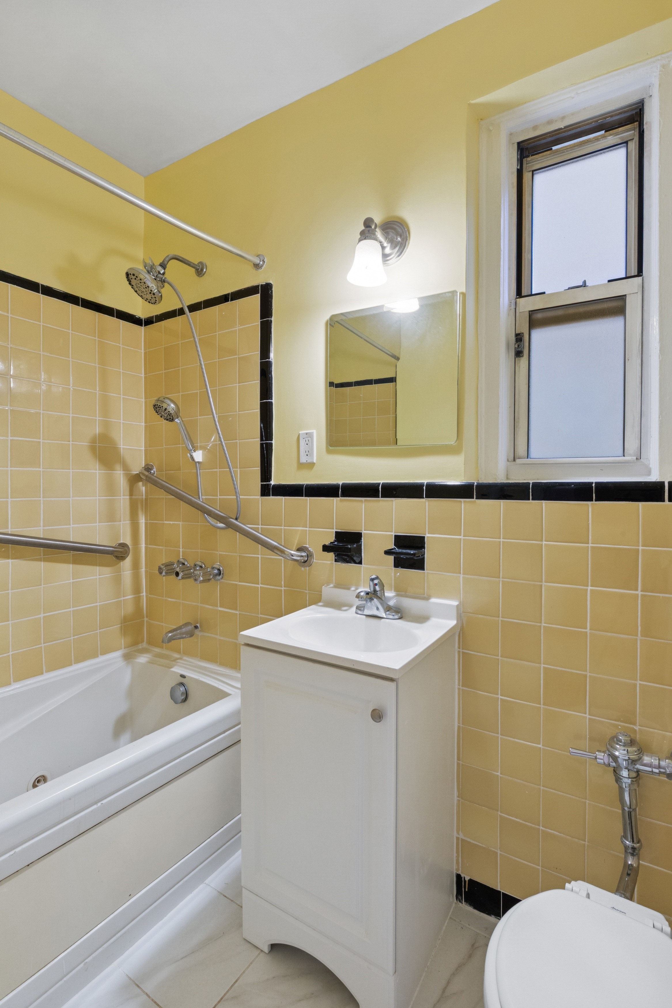 585 West 214th Street, Unit 4G Manhattan, NY 10034 - Photo 10 of 18 a bathroom with a sink a toilet and shower