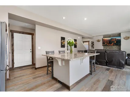 a kitchen with a sink cabinets and wooden floor