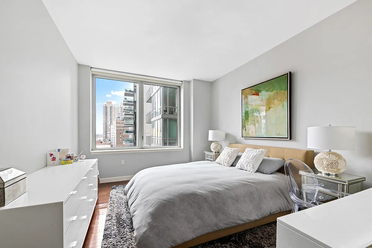 225 East 34th Street, Unit 8B Manhattan, NY 10016 - Photo 6 of 18 a bedroom with two beds and a window