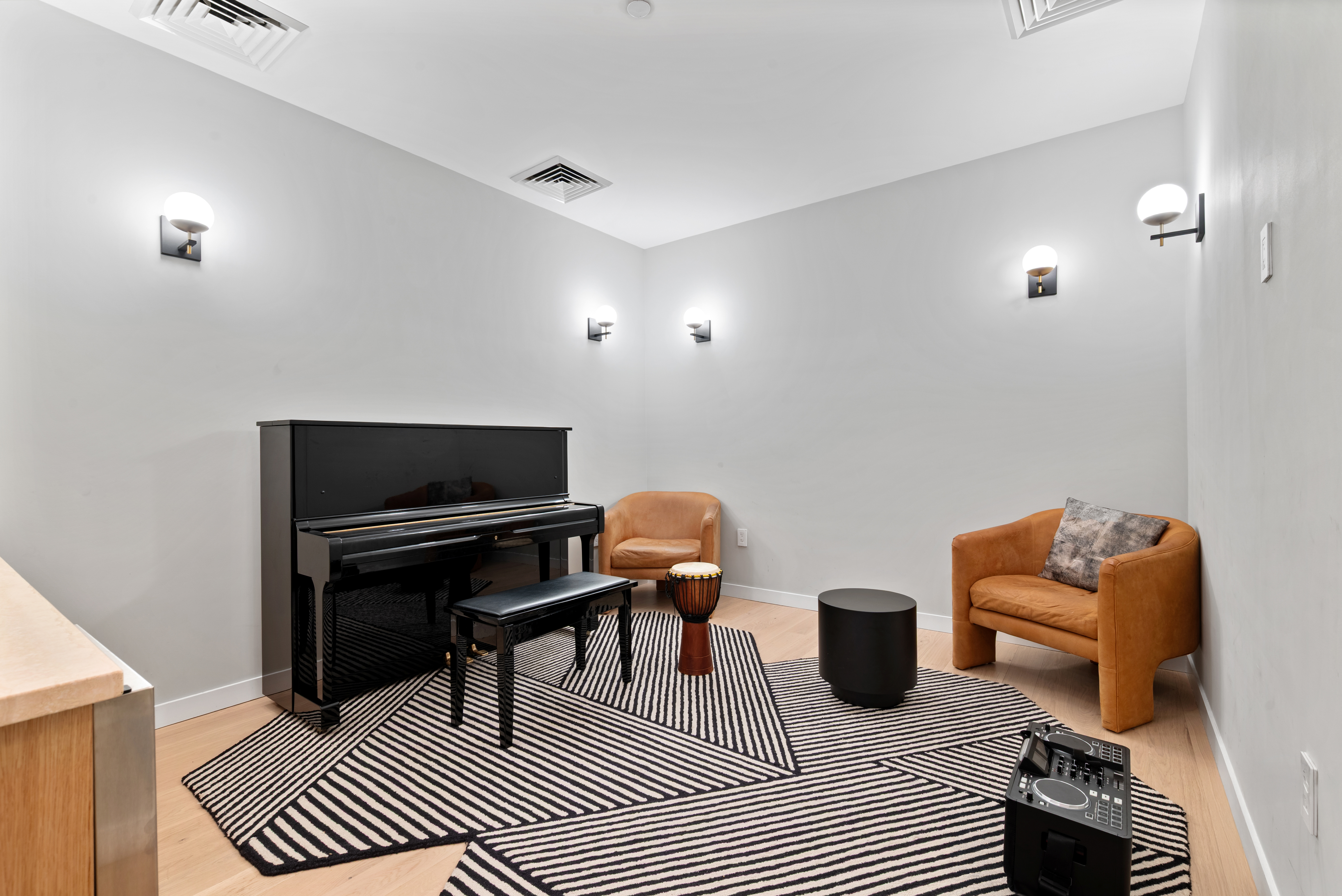 184 Kent Avenue, Unit C107 Brooklyn, NY 11249 - Photo 11 of 18 a living room with furniture a piano and a flat screen tv