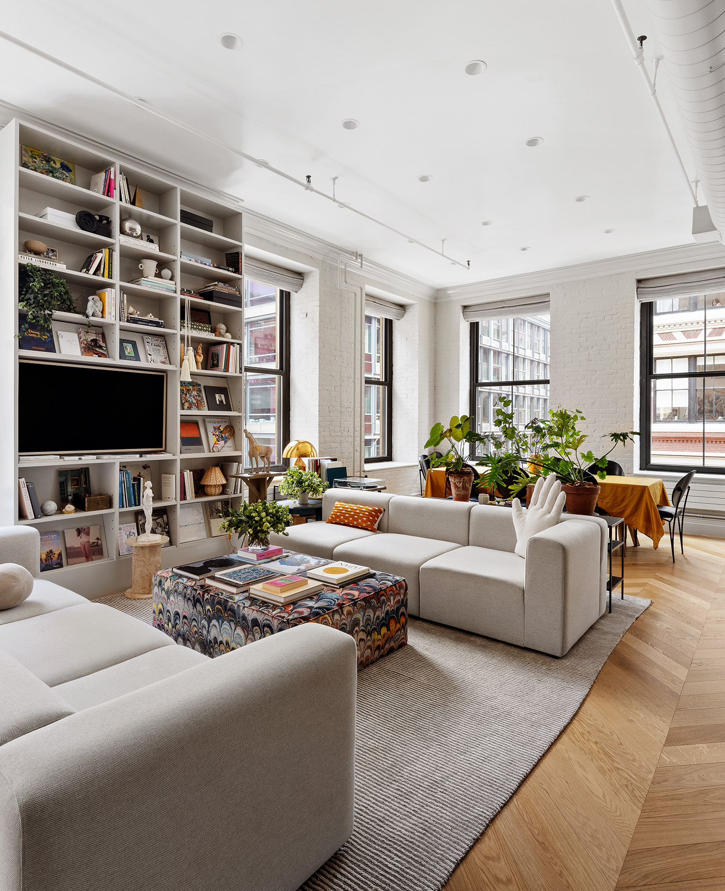 35 Mercer Street, Unit 3E Manhattan, NY 10013 - Photo 2 of 21 a living room with furniture a flat screen tv and a large window