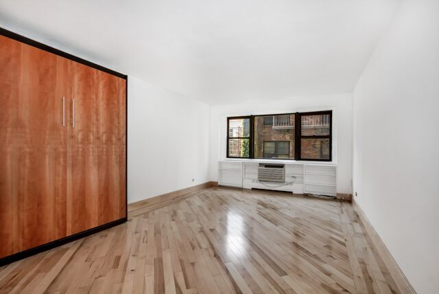 a view of wooden floor and windows in a room
