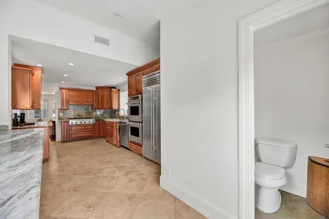 a large open kitchen with a sink and a stove top oven